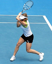 Image of a woman preparing to stroke a tennis ball with her racquet