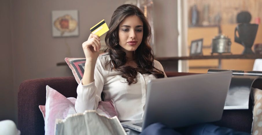Image of woman in front of lapbtop with credit card