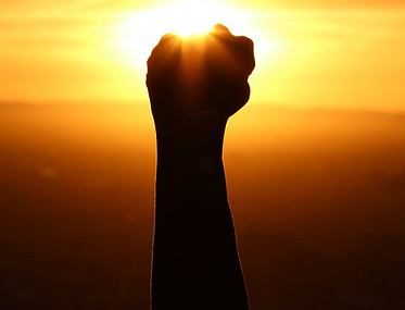 image of clenched fist held high in triumph