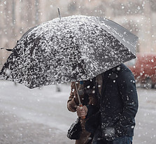 Image of person with umbrella in falling snow