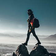 Image of person walking on high mountaintop