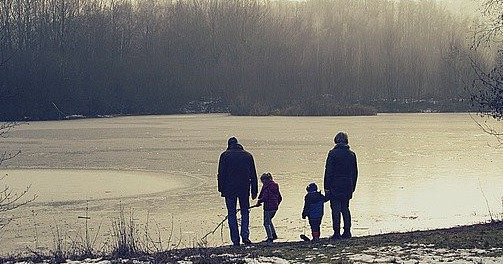 Image of two grandparents and two kids along a lakefront.